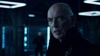 Movie still from “Underworld: Blood Wars” (2016), directed by Anna Foerster – An older bald man wearing a black jacket; Close Up shot, Over the shoulder angle