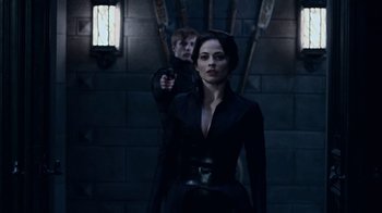 Movie still from “Underworld: Blood Wars” (2016), directed by Anna Foerster – A woman and a boy in a dark room; Medium shot, Over the shoulder angle