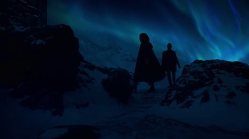 Movie still from “Underworld: Blood Wars” (2016), directed by Anna Foerster – Two people are walking in the snow at night under the lights; Extreme Wide shot, Low angle