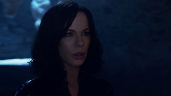 Movie still from “Underworld: Blood Wars” (2016), directed by Anna Foerster – A beautiful woman with long black hair wearing a black shirt; Close Up shot, Over the shoulder angle