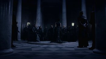 Movie still from “Underworld: Blood Wars” (2016), directed by Anna Foerster – A group of people sitting in a dark room; Wide shot, High angle