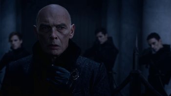 Movie still from “Underworld: Blood Wars” (2016), directed by Anna Foerster – A bald man with a black jacket and a black glove; Close Up shot, Over the shoulder angle