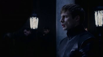 Movie still from “Underworld: Blood Wars” (2016), directed by Anna Foerster – A man in a leather jacket standing next to two other men; Close Up shot, Over the shoulder angle