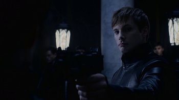 Movie still from “Underworld: Blood Wars” (2016), directed by Anna Foerster – A young man holding a gun in a dark room; Close Up shot, Over the shoulder angle