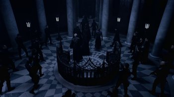 Movie still from “Underworld: Blood Wars” (2016), directed by Anna Foerster – A group of people standing in a circle in front of a building; Extreme Wide shot, High angle