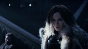 Movie still from “Underworld: Blood Wars” (2016), directed by Anna Foerster – A woman in a white fur coat standing on a staircase; Close Up shot, Over the shoulder angle