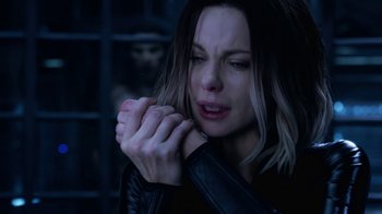 Movie still from “Underworld: Blood Wars” (2016), directed by Anna Foerster – A woman with her hands clasped in front of her face; Close Up shot, Over the shoulder angle