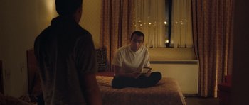 Movie still from “United 93” (2006), directed by Paul Greengrass – A man sitting on top of a bed next to another man; Medium shot, Over the shoulder angle