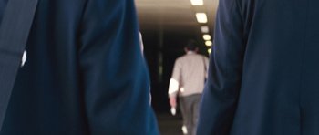 Movie still from “United 93” (2006), directed by Paul Greengrass – A man walking down a hallway in a building; Extreme Close Up shot, Low angle