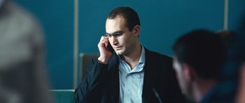 Movie still from “United 93” (2006), directed by Paul Greengrass – A man in a business suit talking on a cell phone; Close Up shot, Low angle