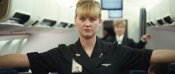 Movie still from “United 93” (2006), directed by Paul Greengrass – A woman in a uniform with a badge on her chest; Close Up shot, Low angle