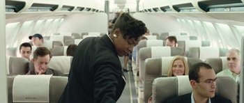 Movie still from “United 93” (2006), directed by Paul Greengrass – A man standing on an airplane looking down at the floor; Medium shot, Over the shoulder angle