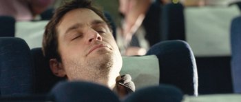 Movie still from “United 93” (2006), directed by Paul Greengrass – A person sleeping on a plane; Close Up shot, High angle