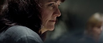 Movie still from “United 93” (2006), directed by Paul Greengrass – A woman's face in a dimly - lit room; Extreme Close Up shot, Low angle