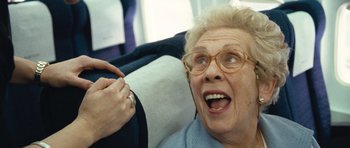 Movie still from “United 93” (2006), directed by Paul Greengrass – An older woman with glasses is looking up at the sky; Close Up shot, Low angle