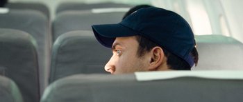 Movie still from “United 93” (2006), directed by Paul Greengrass – A person wearing a hat; Close Up shot, Over the shoulder angle