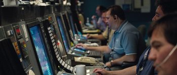 Movie still from “United 93” (2006), directed by Paul Greengrass – A group of people sitting at computers in a room; Medium shot, High angle