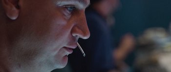 Movie still from “United 93” (2006), directed by Paul Greengrass – A person with a cigarette in his mouth; Close Up shot, Low angle