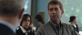 Movie still from “United 93” (2006), directed by Paul Greengrass – A man and a woman standing next to each other in a room; Close Up shot, Over the shoulder angle