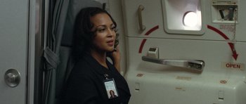 Movie still from “United 93” (2006), directed by Paul Greengrass – A woman in a black shirt is talking on a phone; Close Up shot, Over the shoulder angle
