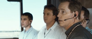 Movie still from “United 93” (2006), directed by Paul Greengrass – A group of men standing next to each other in a room; Close Up shot, Low angle