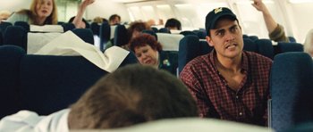 Movie still from “United 93” (2006), directed by Paul Greengrass – A group of people sitting on a plane; Medium shot, Over the shoulder angle