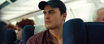 Movie still from “United 93” (2006), directed by Paul Greengrass – A person wearing a hat on a bus; Close Up shot, High angle