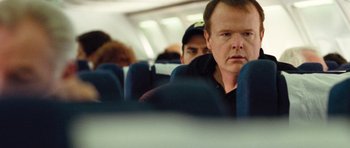 Movie still from “United 93” (2006), directed by Paul Greengrass – A man sitting on a seat on an airplane; Close Up shot, Over the shoulder angle