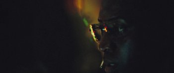 Movie still from “United 93” (2006), directed by Paul Greengrass – A man wearing glasses and smoking a cigarette in the dark; Extreme Close Up shot, Low angle