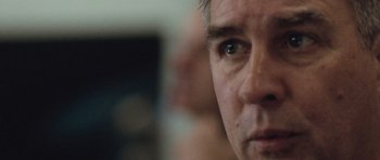 Movie still from “United 93” (2006), directed by Paul Greengrass – A man's face with a blurry background behind it; Extreme Close Up shot, Over the shoulder angle