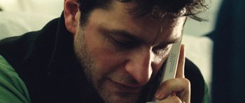 Movie still from “United 93” (2006), directed by Paul Greengrass – A person talking on a cell phone; Extreme Close Up shot, High angle