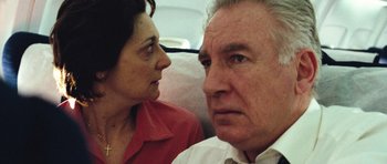 Movie still from “United 93” (2006), directed by Paul Greengrass – An older man and a younger woman sitting next to each other; Close Up shot, Low angle