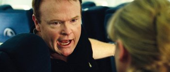 Movie still from “United 93” (2006), directed by Paul Greengrass – A person with his mouth wide open; Close Up shot, Over the shoulder angle