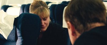 Movie still from “United 93” (2006), directed by Paul Greengrass – A woman sitting on a seat next to another person; Close Up shot, Over the shoulder angle