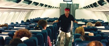 Movie still from “United 93” (2006), directed by Paul Greengrass – A man walking on the aisle of an airplane; Wide shot, High angle