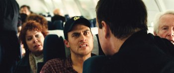 Movie still from “United 93” (2006), directed by Paul Greengrass – A man in a hat is talking to another man; Close Up shot, Over the shoulder angle