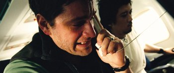 Movie still from “United 93” (2006), directed by Paul Greengrass – A person talking on a cell phone; Close Up shot, High angle