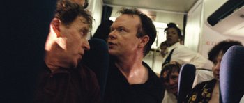 Movie still from “United 93” (2006), directed by Paul Greengrass – Two men are standing next to each other on a bus; Close Up shot, Over the shoulder angle