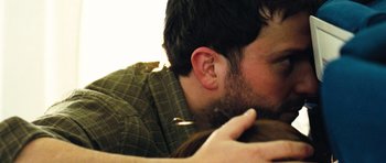 Movie still from “United 93” (2006), directed by Paul Greengrass – A person kissing another person on the cheek; Extreme Close Up shot, Over the shoulder angle