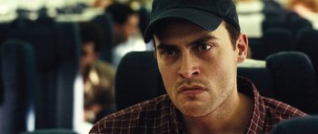 Movie still from “United 93” (2006), directed by Paul Greengrass – A person wearing a hat; Close Up shot, Over the shoulder angle