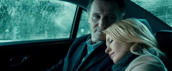 Movie still from “Unknown” (2011), directed by Jaume Collet-Serra – A man and a woman sitting in the back seat of a car; Close Up shot, Low angle
