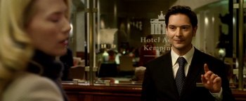 Movie still from “Unknown” (2011), directed by Jaume Collet-Serra – A man standing in front of a restaurant window; Close Up shot, Low angle