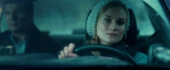 Movie still from “Unknown” (2011), directed by Jaume Collet-Serra – A woman sitting in the drivers seat of a car; Close Up shot, Over the shoulder angle