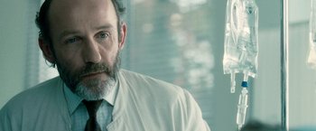 Movie still from “Unknown” (2011), directed by Jaume Collet-Serra – A man in a white shirt and a black tie; Close Up shot, Low angle