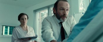 Movie still from “Unknown” (2011), directed by Jaume Collet-Serra – A man in a white shirt and a black tie; Close Up shot, Over the shoulder angle