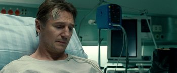 Movie still from “Unknown” (2011), directed by Jaume Collet-Serra – A man sitting in a hospital bed with a bandage on his head; Close Up shot, Low angle