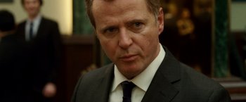 Movie still from “Unknown” (2011), directed by Jaume Collet-Serra – A person wearing a suit and tie; Close Up shot, Over the shoulder angle