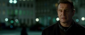 Movie still from “Unknown” (2011), directed by Jaume Collet-Serra – A man in a black jacket standing in front of a building at night; Close Up shot, Over the shoulder angle