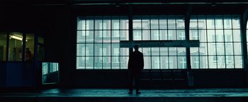Movie still from “Unknown” (2011), directed by Jaume Collet-Serra – A man standing in front of a window at night; Wide shot, Low angle