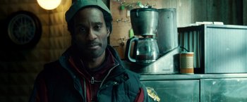 Movie still from “Unknown” (2011), directed by Jaume Collet-Serra – A man standing in front of a coffee maker; Close Up shot, Over the shoulder angle